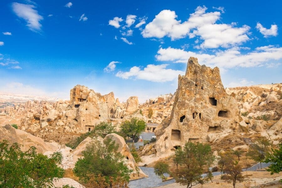 A scenic view of Goreme Open Air Museum featuring ancient cave churches and frescoes in a rocky landscape.
