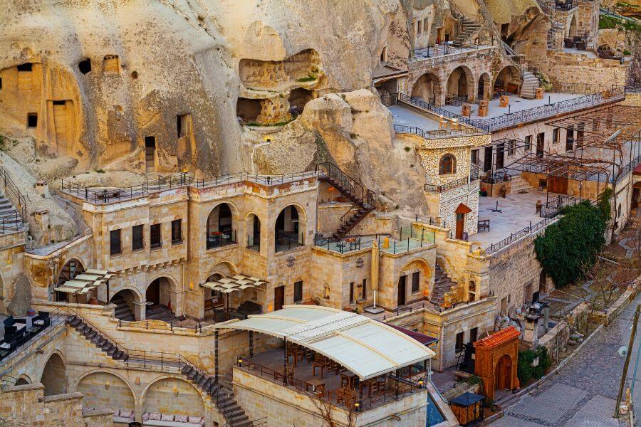 Luxurious cave hotel room in Cappadocia with elegant furnishings and natural rock walls.