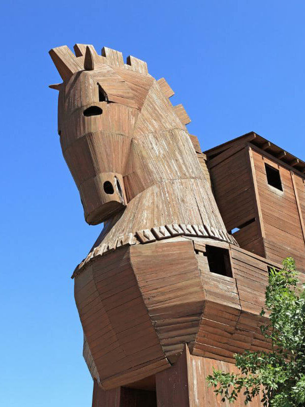 Wooden Trojan Horse replica under blue sky at the ancient city of Troy in Çanakkale, Turkey.
