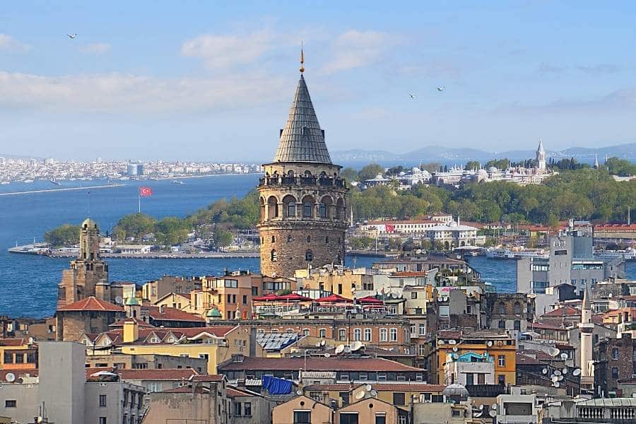 A panoramic view of the Galata Tower surrounded by Istanbul’s vibrant cityscape and the Bosphorus in the background