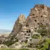 Uchisar Castle in Cappadocia, towering rock formation with carved rooms