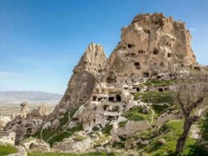 Uchisar Castle in Cappadocia, towering rock formation with carved rooms