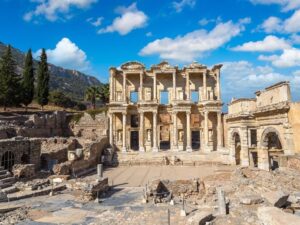 Ephesus Ancient City Ruins with well-preserved columns, pathways, and historical structures under a clear sky.