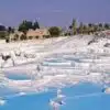 White terraces of Pamukkale Hot Springs in Turkey, reflecting sunlight.