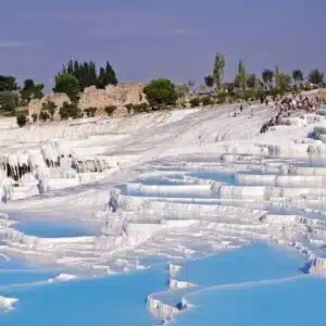 White terraces of Pamukkale Hot Springs in Turkey, reflecting sunlight.