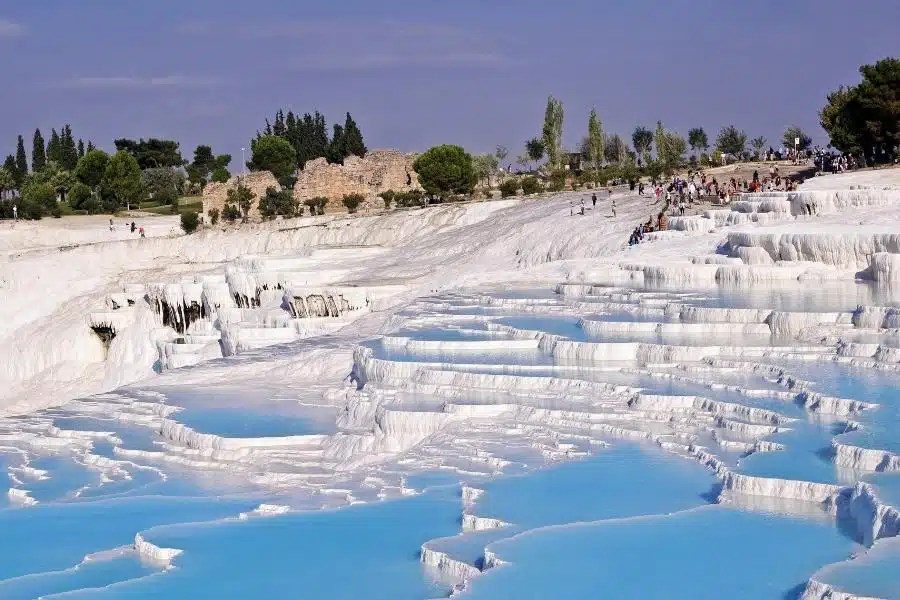 White terraces of Pamukkale Hot Springs in Turkey, reflecting sunlight.