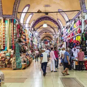 Vibrant interior of Istanbul's Grand Bazaar, showcasing diverse shops with colorful textiles and traditional crafts.