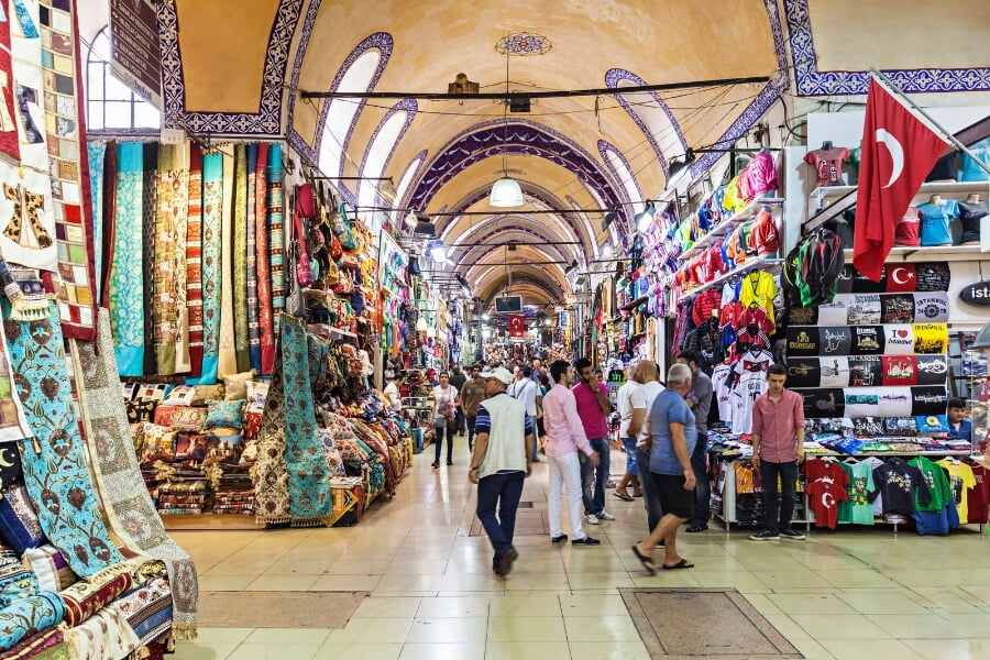 Vibrant interior of Istanbul's Grand Bazaar, showcasing diverse shops with colorful textiles and traditional crafts.