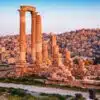 Amman cityscape featuring modern high-rise buildings and ancient ruins, highlighting its blend of contemporary and historic architecture.