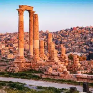 Amman cityscape featuring modern high-rise buildings and ancient ruins, highlighting its blend of contemporary and historic architecture.