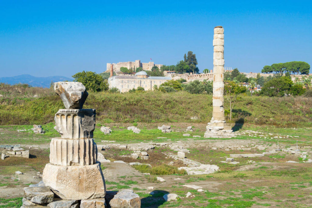 Scattered marble ruins and a single standing column from the Temple of Artemis in Ephesus, Turkey.
