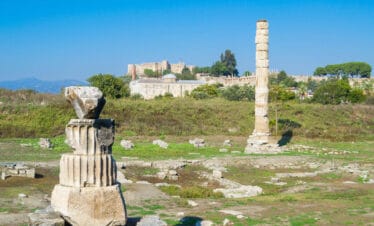 Scattered marble ruins and a single standing column from the Temple of Artemis in Ephesus, Turkey.