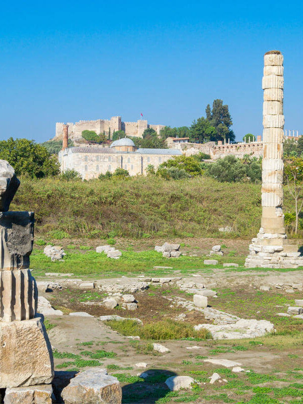 Scattered marble ruins and a single standing column from the Temple of Artemis in Ephesus, Turkey.