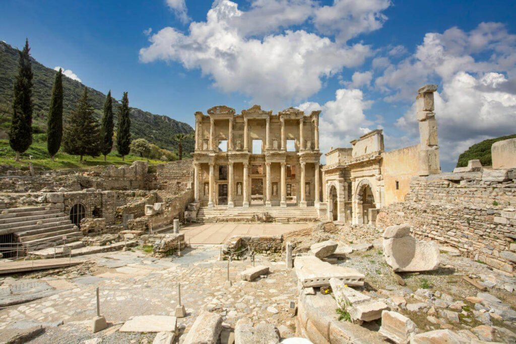 Front view of the Celsus Library in Ephesus, Turkey with grand marble columns and ornate Roman architecture.