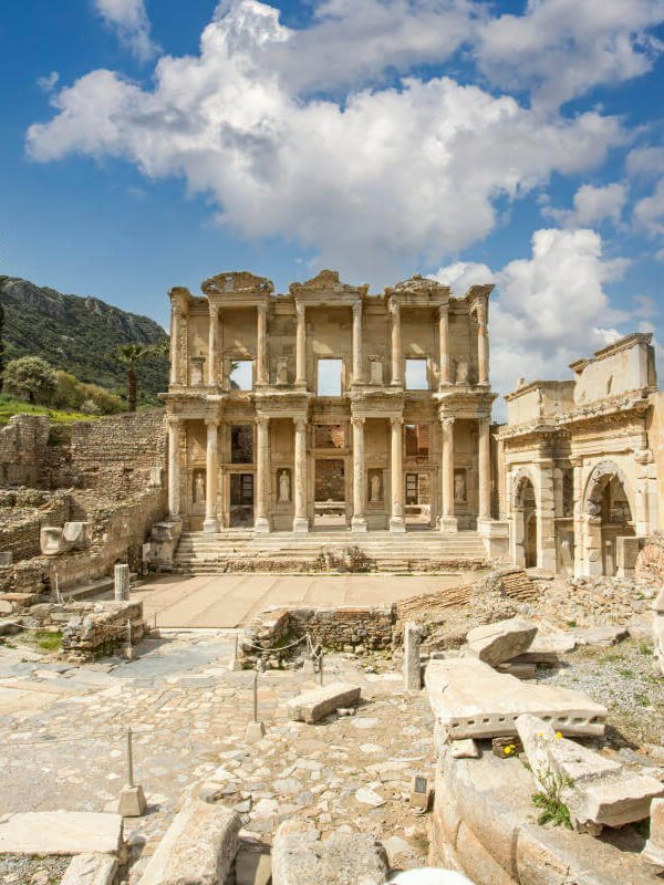 Front view of the Celsus Library in Ephesus, Turkey with grand marble columns and ornate Roman architecture.