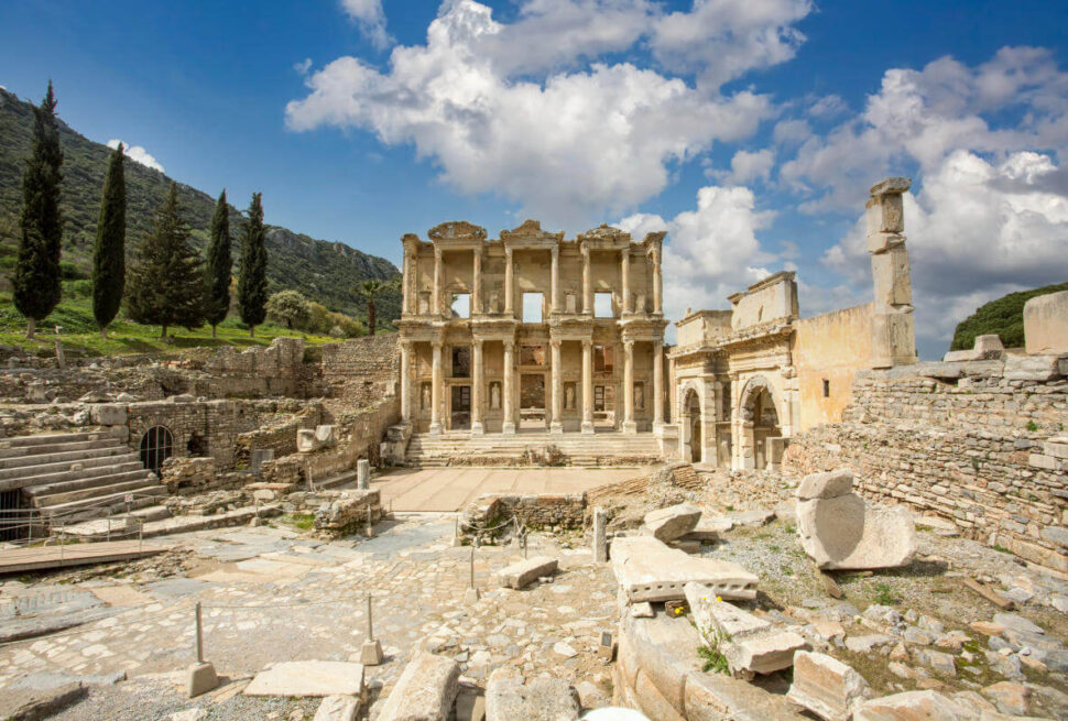 Front view of the Celsus Library in Ephesus, Turkey with grand marble columns and ornate Roman architecture.