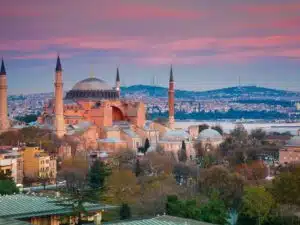 Exterior of Hagia Sophia with its massive domes and minarets, blending Byzantine and Islamic architectural styles.