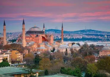 Exterior of Hagia Sophia with its massive domes and minarets, blending Byzantine and Islamic architectural styles.