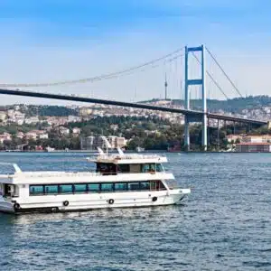 Scenic view of a Bosphorus cruise ship sailing through Istanbul, showcasing historic landmarks and city skyline.