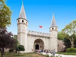 Ornate main entrance of Topkapi Palace Museum, featuring grand arches and intricate Islamic art details.