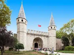 Ornate main entrance of Topkapi Palace Museum, featuring grand arches and intricate Islamic art details.