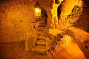 Interior of Kaymaklı Underground City, showcasing narrow passageways and carved stone rooms