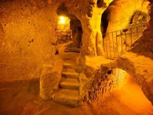Interior of Kaymaklı Underground City, showcasing narrow passageways and carved stone rooms