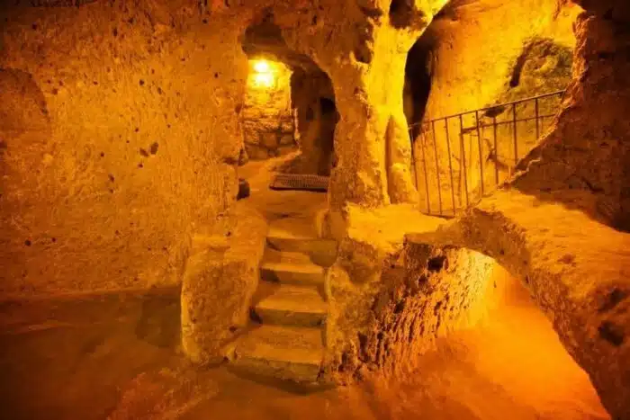 Interior of Kaymaklı Underground City, showcasing narrow passageways and carved stone rooms