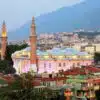 Bursa Grand Mosque with intricate Islamic architecture, large domes and twin minarets.
