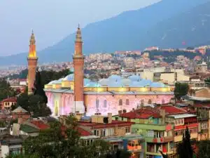 Bursa Grand Mosque with intricate Islamic architecture, large domes and twin minarets.