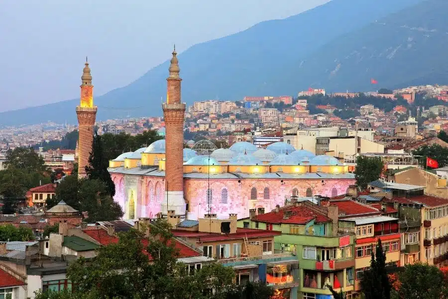 Bursa Grand Mosque with intricate Islamic architecture, large domes and twin minarets.