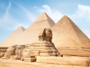 Limestone Great Sphinx of Giza statue under clear sky, showcasing ancient Egyptian craftsmanship.
