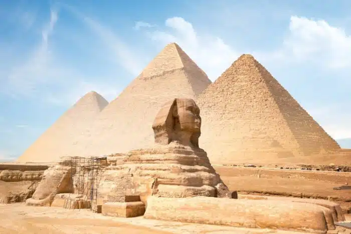 Limestone Great Sphinx of Giza statue under clear sky, showcasing ancient Egyptian craftsmanship.