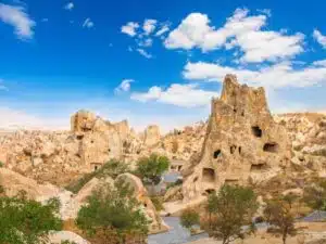 A scenic view of Goreme Open Air Museum featuring ancient cave churches and frescoes in a rocky landscape.
