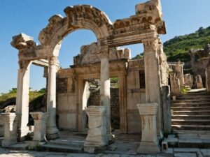 Ruins of the Temple of Hadrian in Ephesus, featuring ornate stone carvings and classical columns.