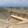 Ruins of ancient Pamukkale Theatre in Turkey, showcasing well-preserved stone seats and stage.