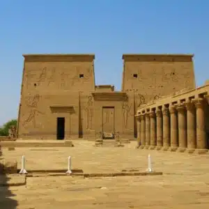 Philae Temple complex in Aswan, Egypt, featuring ancient columns, intricate hieroglyphs, and a serene Nile River backdrop.
