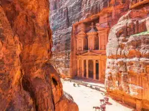 Tourist exploring the ancient city of Petra in Jordan, showcasing iconic sandstone architecture.