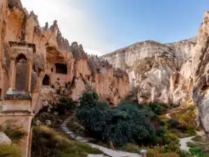For an outdoor image of the Zelve Open Air Museum, consider this description: "Panoramic view of Zelve Open Air Museum, showcasing weathered rock formations and cave entrances under a clear blue sky.