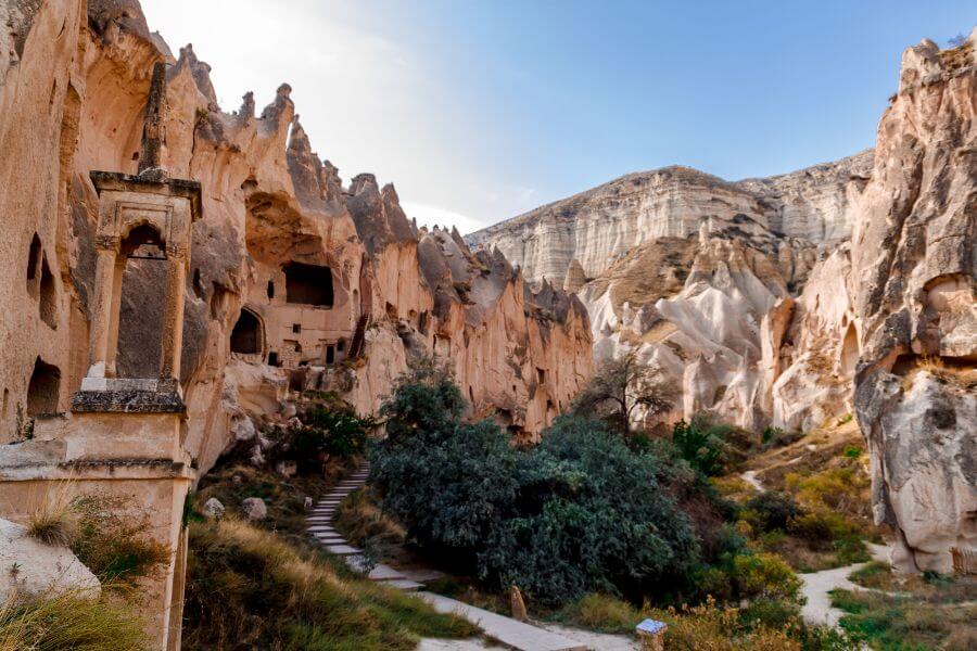 For an outdoor image of the Zelve Open Air Museum, consider this description: "Panoramic view of Zelve Open Air Museum, showcasing weathered rock formations and cave entrances under a clear blue sky.