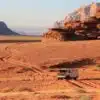 "Safari jeep cruising through the sandy landscape of Wadi Rum.