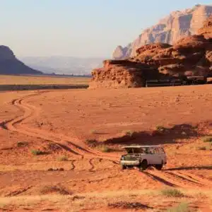 "Safari jeep cruising through the sandy landscape of Wadi Rum.