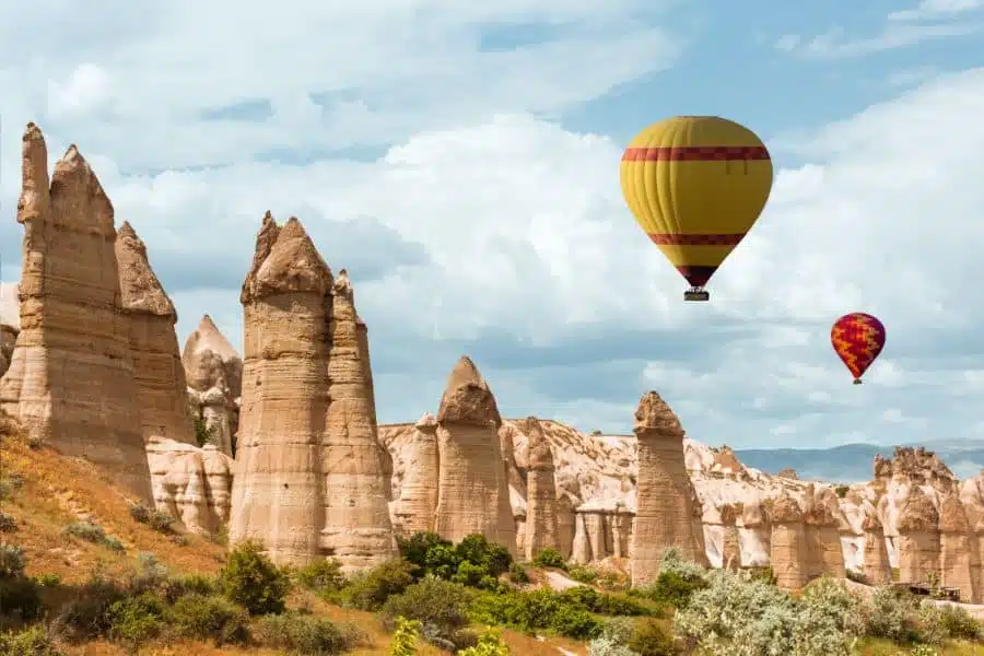 Scenic view of Love Valley in Cappadocia, featuring unique fairy chimneys and rugged landscapes.