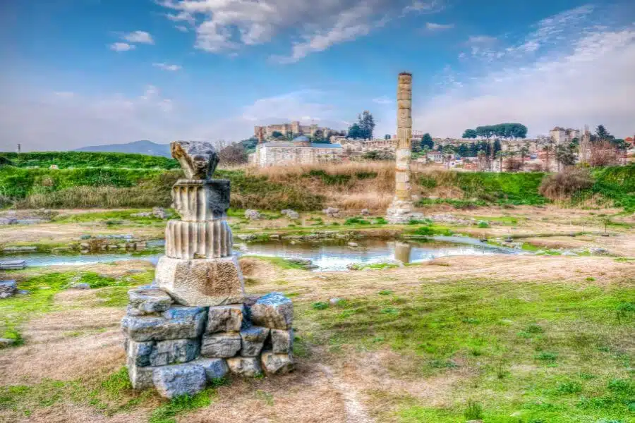 Ruins of the Temple of Artemis, showcasing ancient columns and stone foundations against a clear sky, hinting at the temple's historic grandeur.