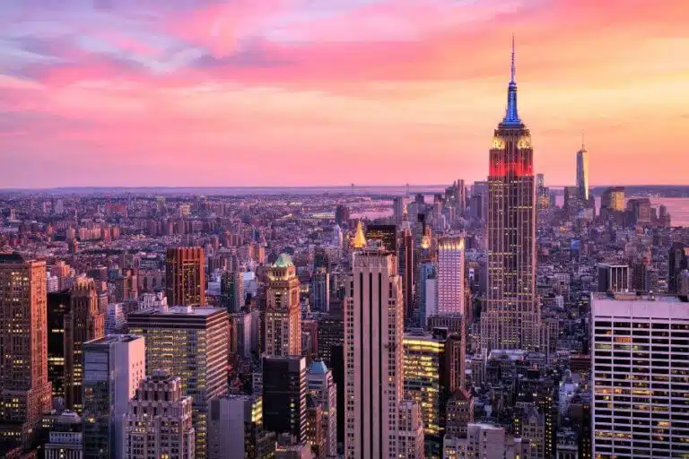 Expansive view of the Manhattan skyline from Top of the Rock, featuring iconic skyscrapers against a clear blue sky.