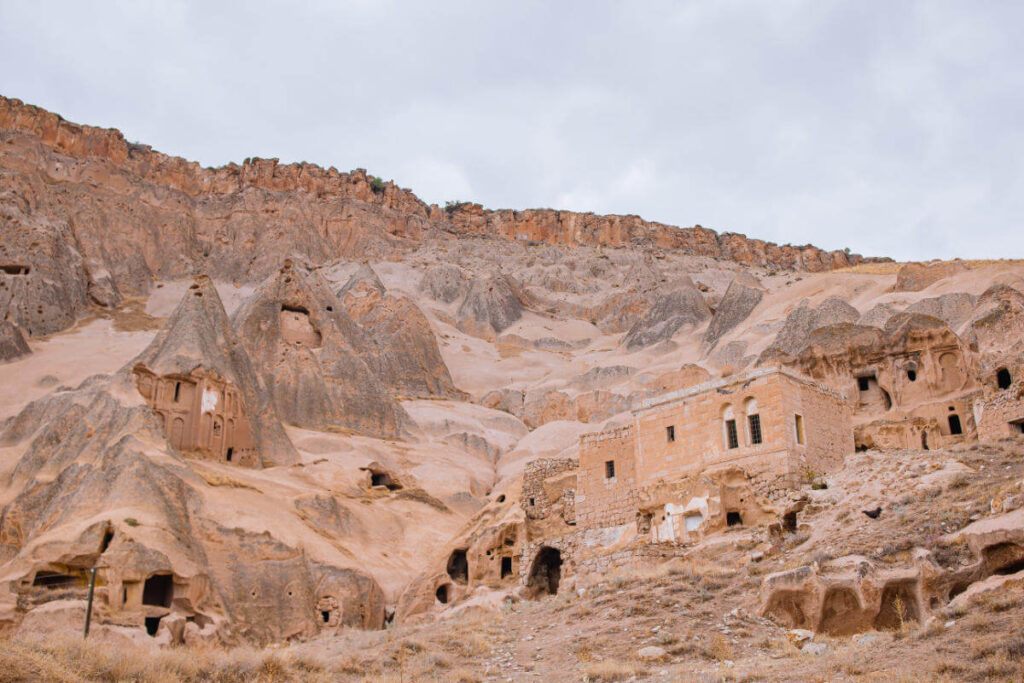 Historic cave dwellings carved into Cappadocia’s rugged cliffs, showcasing ancient rock-cut architecture in Turkey.