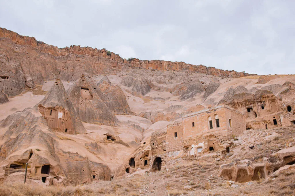 Historic cave dwellings carved into Cappadocia’s rugged cliffs, showcasing ancient rock-cut architecture in Turkey.