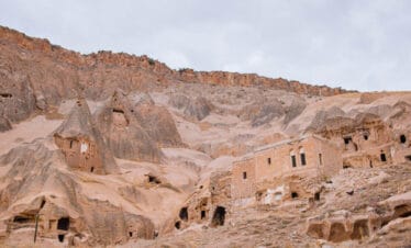 Historic cave dwellings carved into Cappadocia’s rugged cliffs, showcasing ancient rock-cut architecture in Turkey.
