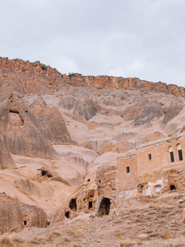 Historic cave dwellings carved into Cappadocia’s rugged cliffs, showcasing ancient rock-cut architecture in Turkey.