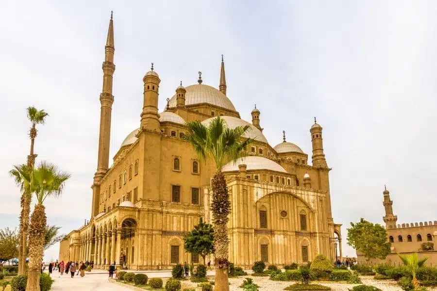 The grand Muhammad Ali Alabaster Mosque in Cairo, featuring large domes, tall minarets, and ornate stone architecture.